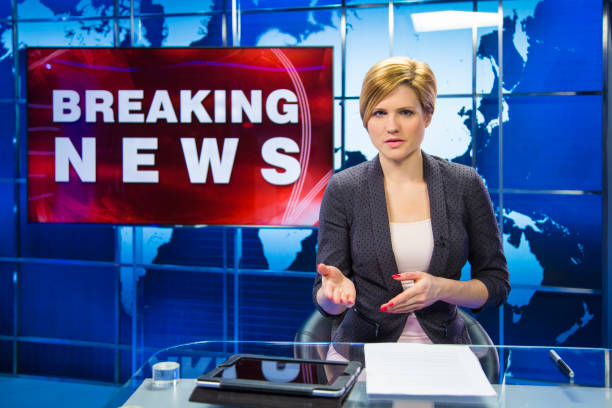istock Breaking news female anchor 991244886