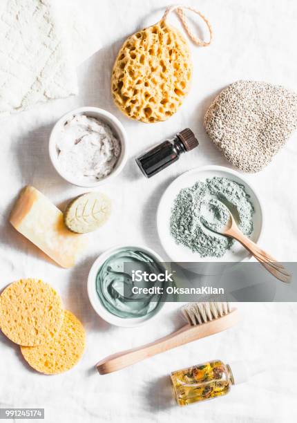 Spa Accessories Nut Scrub Sponge Facial Brush Natural Soap Clay Face Mask Pumice Stone Essential Oil On A Light Background Top View Healthy Lifestyle Concept Beauty Skin Care Flat Lay Stock Photo - Download Image Now