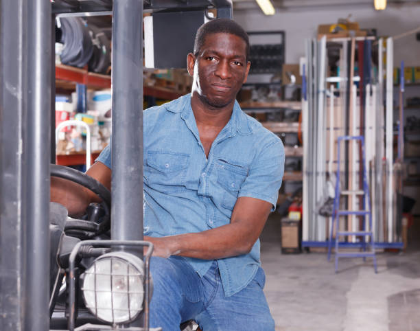 istock Happy worker on forklift in building store 991250054