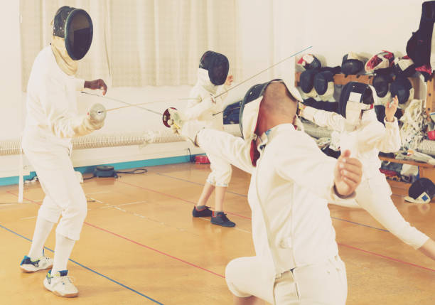 istock Mixed age group of athletes at fencing workout 991254558