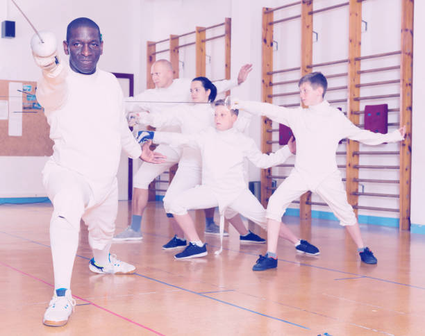istock African American wearing fencing uniform practicing with foil 991254918