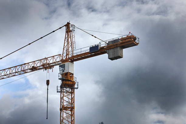 istock Crane - yellow car cranes at highway 991266656