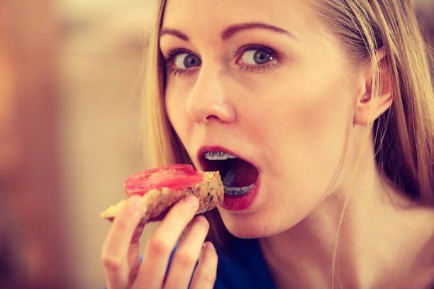 istock Woman having healthy breakfast eating sandwich 991332128
