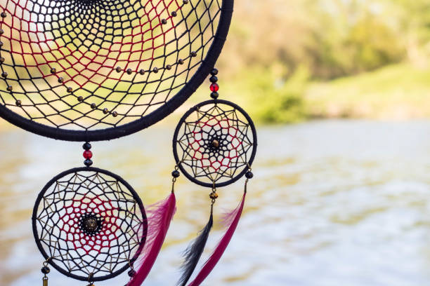 istock Handmade dream catcher with feathers threads and beads rope hanging 991354586