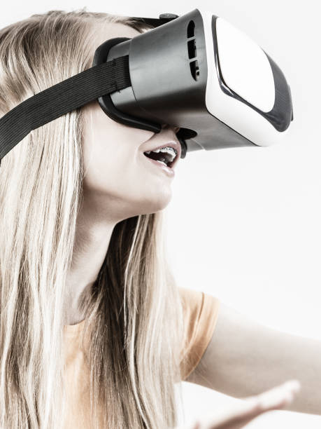 istock Girl wearing virtual reality goggles. 991355226