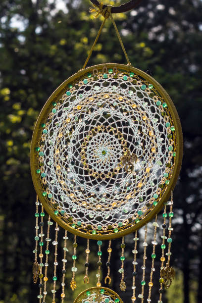 istock Handmade dream catcher with feathers threads and beads rope hanging 991355354