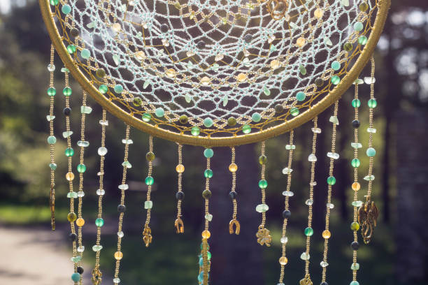 istock Handmade dream catcher with feathers threads and beads rope hanging 991355474