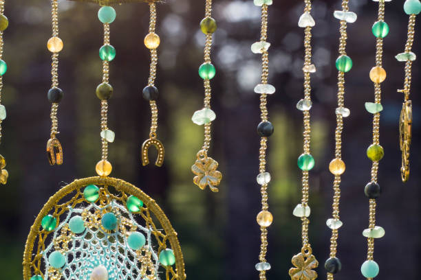 istock Handmade dream catcher with feathers threads and beads rope hanging 991355484