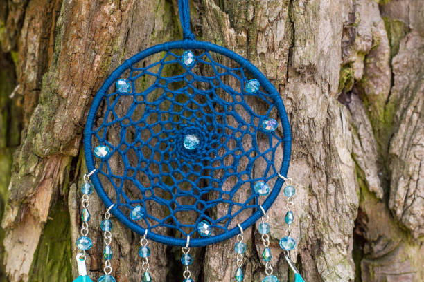 istock Handmade dream catcher with feathers threads and beads rope hanging 991360376