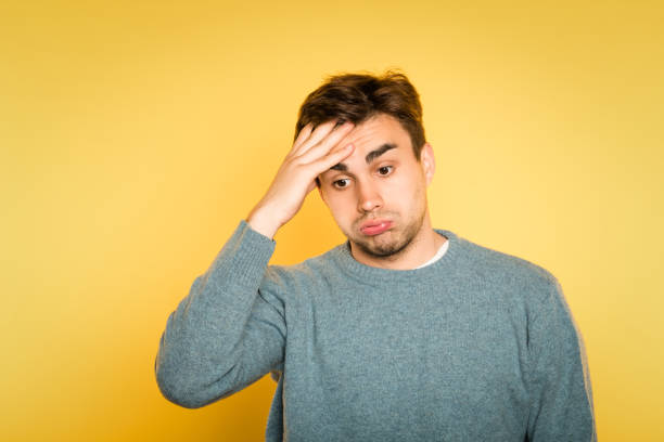 istock overwhelmed dizzy confused man hold head emotion 991360724