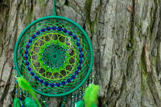 istock Handmade dream catcher with feathers threads and beads rope hanging 991360912