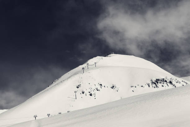istock Ropeway on ski resort and snowy off-piste slope 991360982