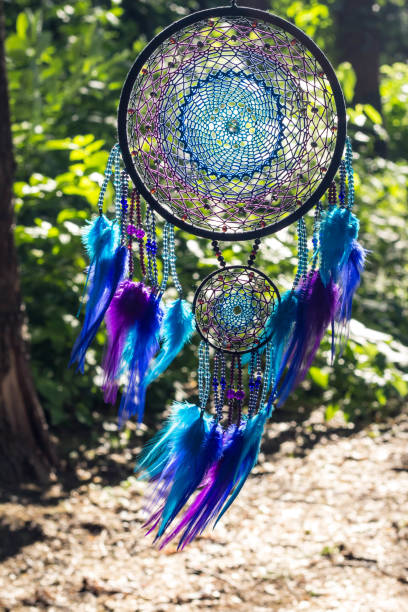 istock Handmade dream catcher with feathers threads and beads rope hanging 991361434
