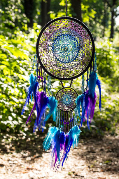 istock Handmade dream catcher with feathers threads and beads rope hanging 991361450