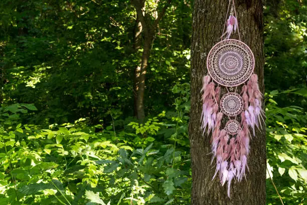 Photo of Handmade dream catcher with feathers threads and beads rope hanging