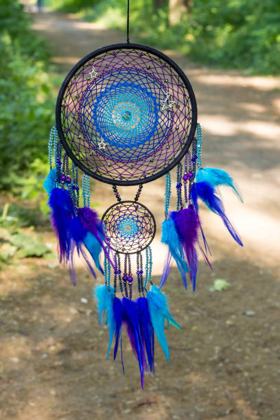 istock Handmade dream catcher with feathers threads and beads rope hanging 991361678