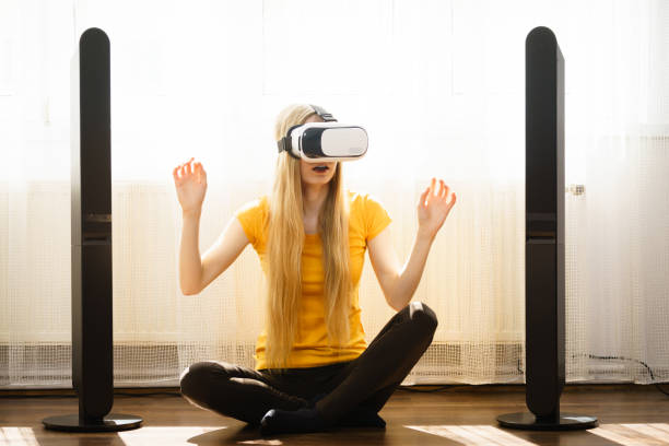 istock Girl wearing virtual reality goggles at home 991363318