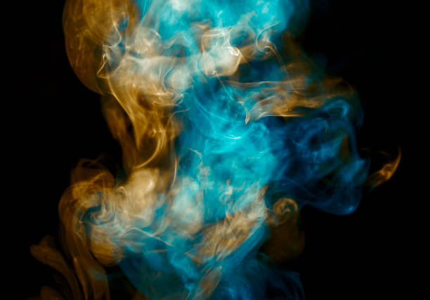 istock Orange and Teal Coloured Steam on Black Background 991363596