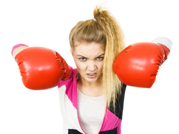istock Angry woman wearing boxing gloves 991367680