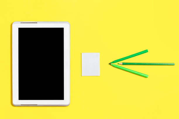 istock green coloured chancery, paper stickers and a tablet pc 991378884