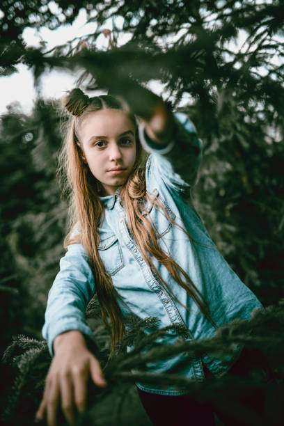 istock Adorable Female Child Playing Hide And Seek In Forest 991384758