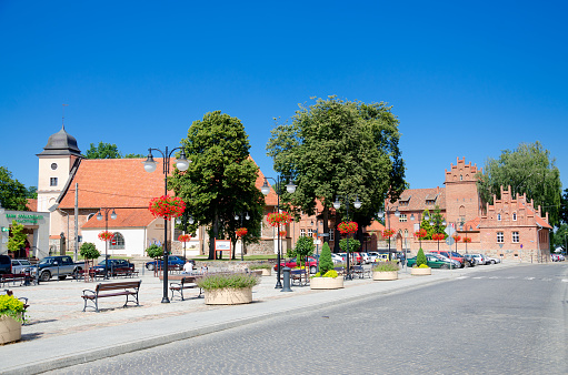 Olsztynek, warmia-masuria province, Poland.  Marketplace in Olsztynek, former Protestant church (currently museum) and castle of Teutonic Order, currently school building.