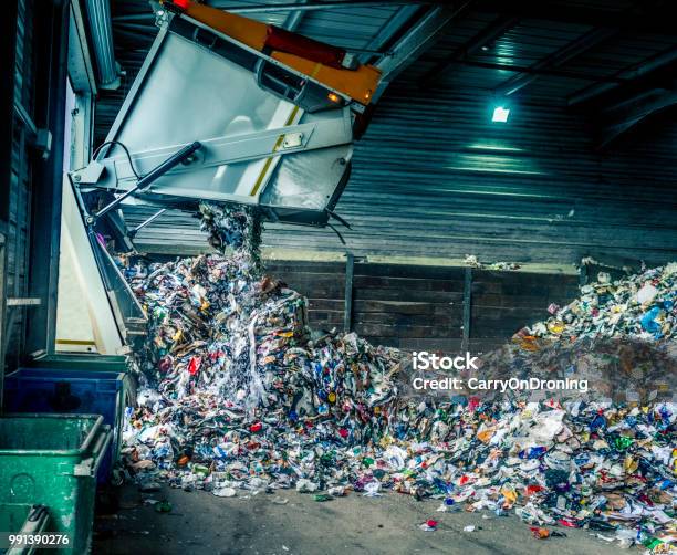 Tipping Recycling Into Storage Shed Stock Photo - Download Image Now - Recycling, Garbage, Plastic