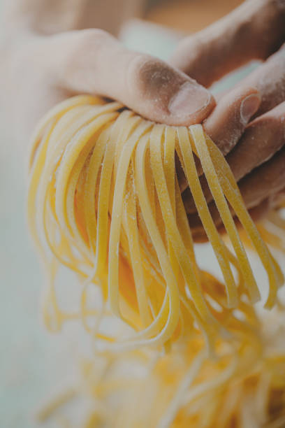 istock Chef holding ready italian homemade pasta 991438838