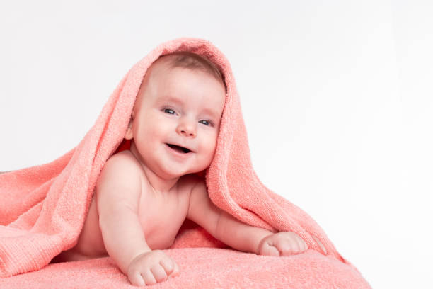 istock Laughing baby after bath wrapped 991440226