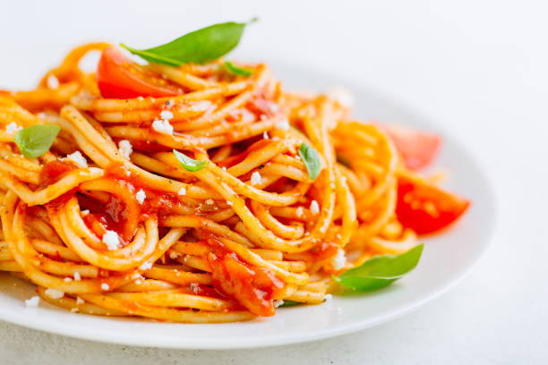 istock Pasta dish with tomato sauce on white plate 991440518