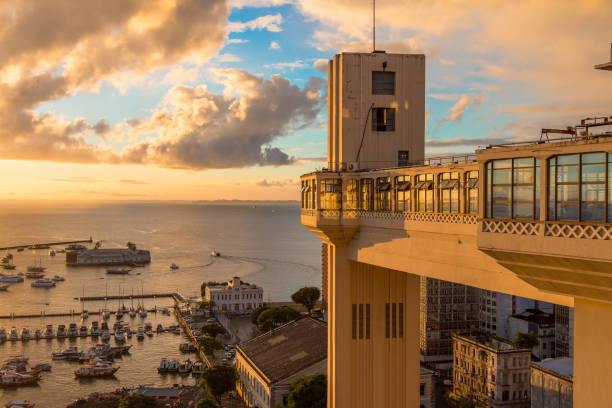 View of the Lacerda Elevator with beautiful sunset - Salvador, Bahia Brazil Sunset with golden lights in the elevator Lacerda famous tourist spot of the city of Salvador Bahia Brazil lacerda elevator stock pictures, royalty-free photos & images