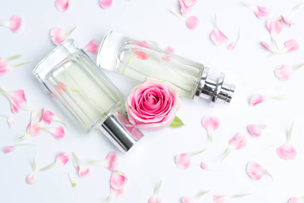 istock Beautiful perfume bottles  and rose on white background 991547446