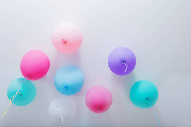 istock balloons on white wooden background 991578372
