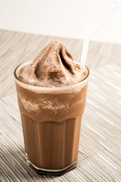 istock Ice coffee in a tall glass with cream . 991590728
