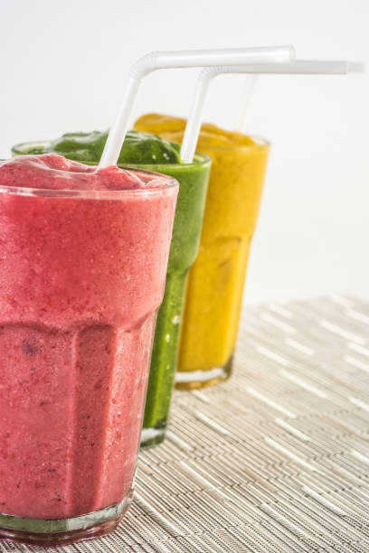 istock Colorful smoothies with raspbeerries, blueberries, banana, pineapple, mango, arugula and apple 991591208