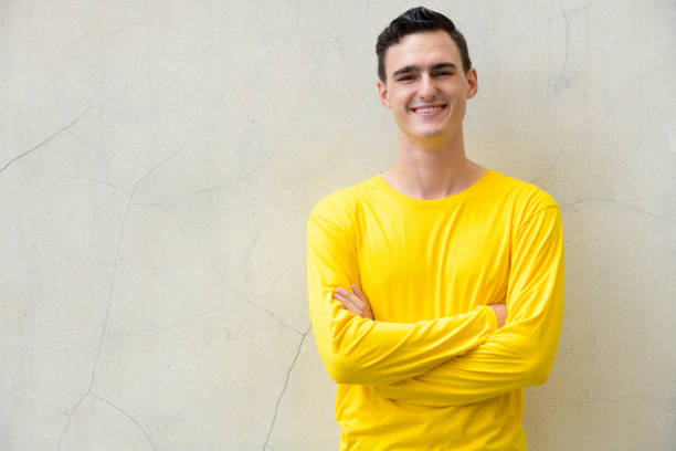 istock Young happy handsome man smiling with arms crossed 991595072