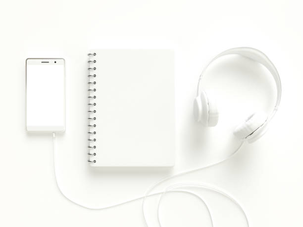 istock Notebook with smartphone and headphones white color 991599346