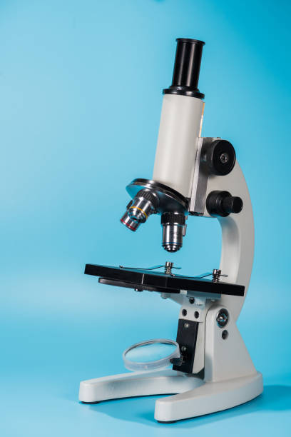 Close-Up Of Microscope On Blue Background  microscope isolated stock pictures, royalty-free photos & images