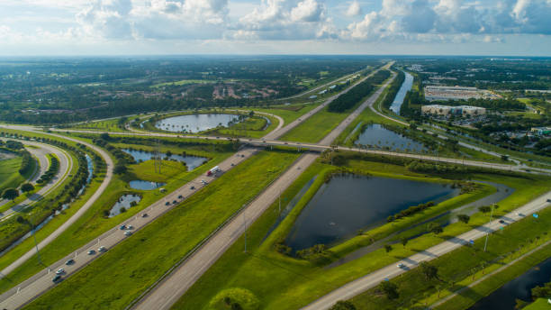 istock Aerial highway interchange with green landscape 991604256