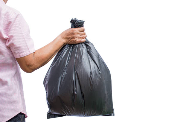istock Midsection Of Man Holding Garbage Bag Against White Background 991604818