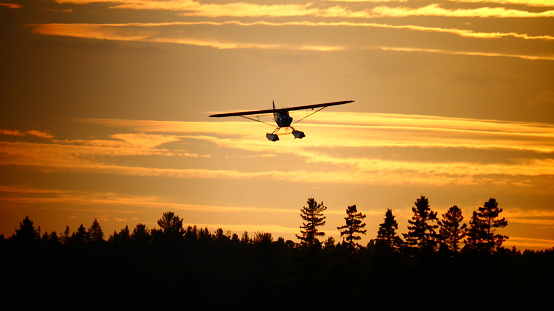 Plane in a sunset over the mountain