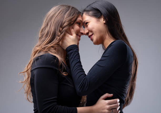 couple of women about to kiss each other - homosexual beautiful sensuality love imagens e fotografias de stock