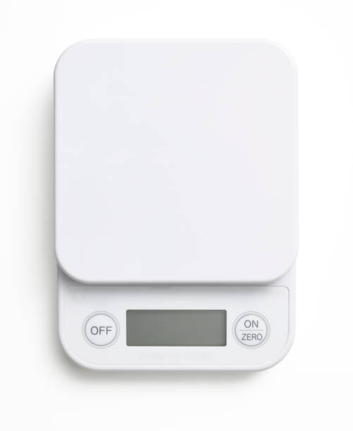 Isolated shot of kitchen digital food weight scale on white background Close-up of kitchen digital food weight scale, isolated on white with clipping path. kitchen scale stock pictures, royalty-free photos & images