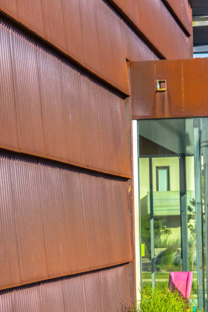 istock Metal panels of building in sun with window 991708964