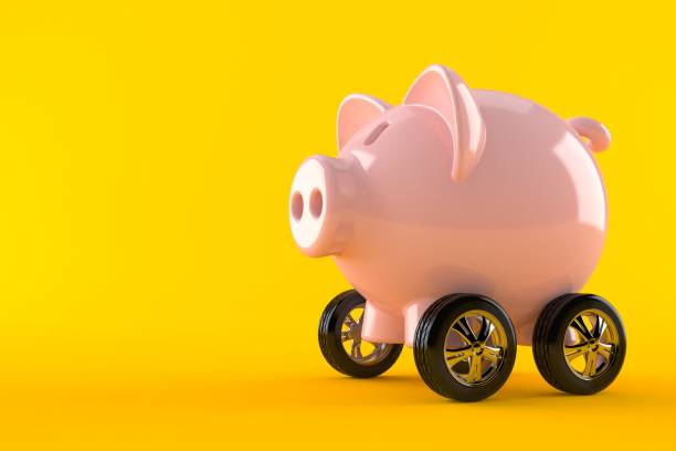 istock Piggy bank with car wheels 991713582