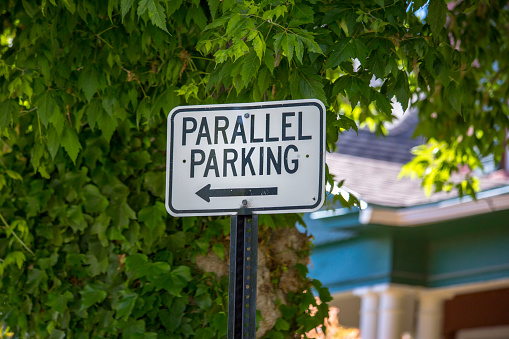 Parallel parking sign with tree and other foliage in Salt Lake City