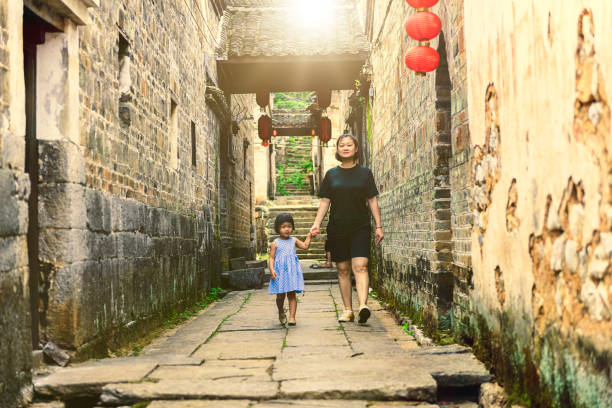 Blue stone street surrounded by karst mountains in Huangyao, a picturesque town in Zhaoping County, Guangxi, China. The old town of Huangyao has a history of around a thousand years, and many of its buildings date from the Qing dynasty.