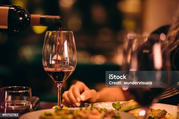 Closeup Of Sommelier Serving Red Wine At Fine Dining Restaurant Stock Photo - Download Image Now