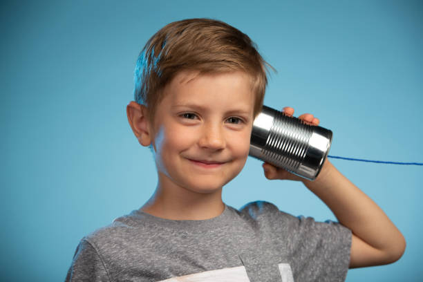 istock Adorable Little Boy with a Tin Can Phone 991733046