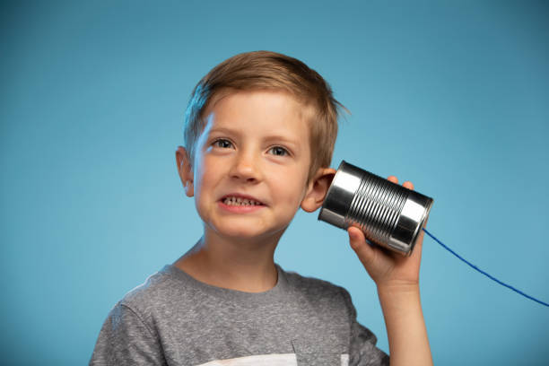 istock Adorable Little Boy with a Tin Can Phone 991733114